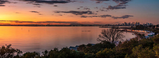 Brighton beach boxes with city back drop sunset panorama